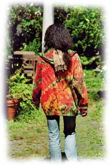 woman wearing mudmee tie dye hoodie strolling through nature